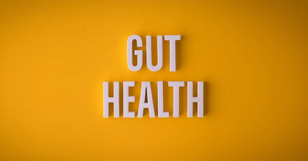 a yellow poster with the words ‘Gut Health’ written on it in bold white 3d font