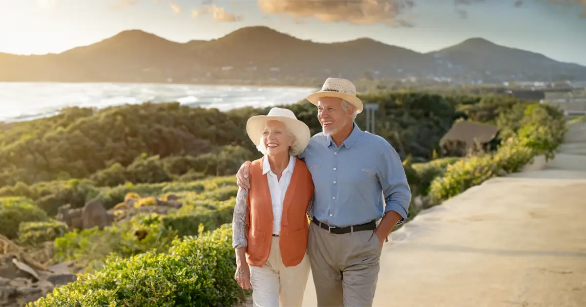 A couple walking together in the countryside smiling and feeling content