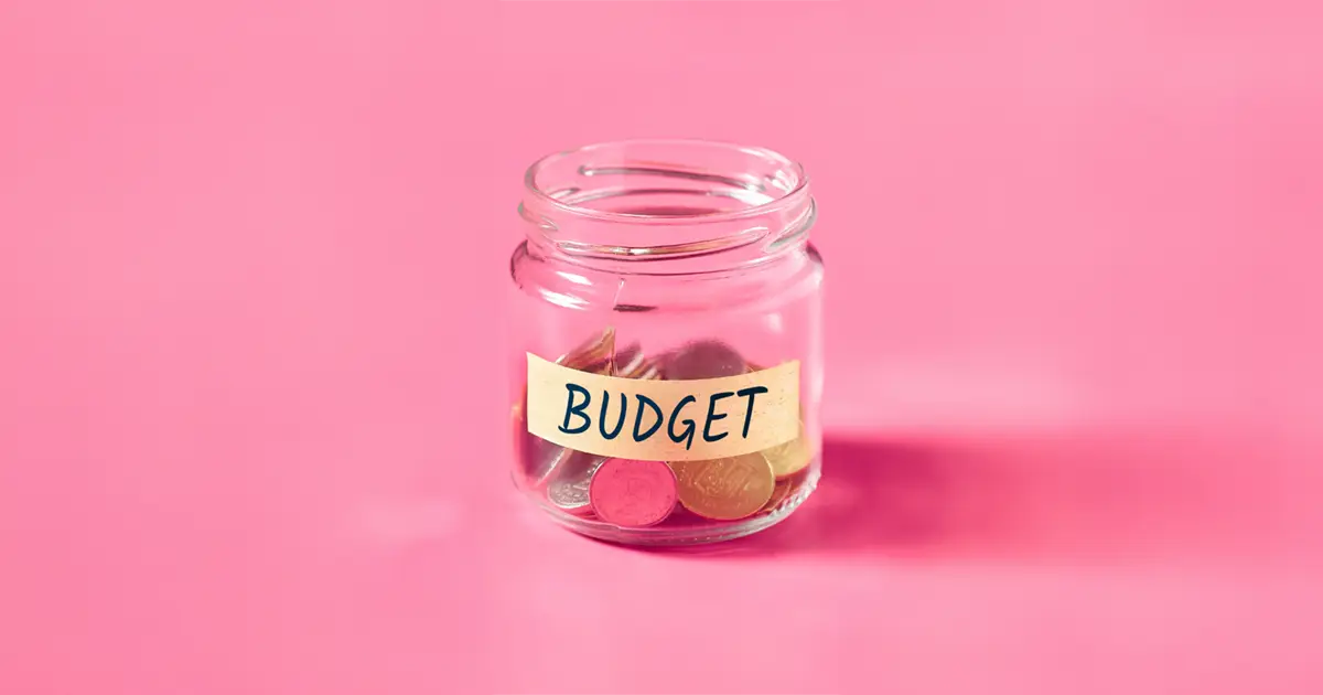 a cup of coins labelled budget – what a budget can look like