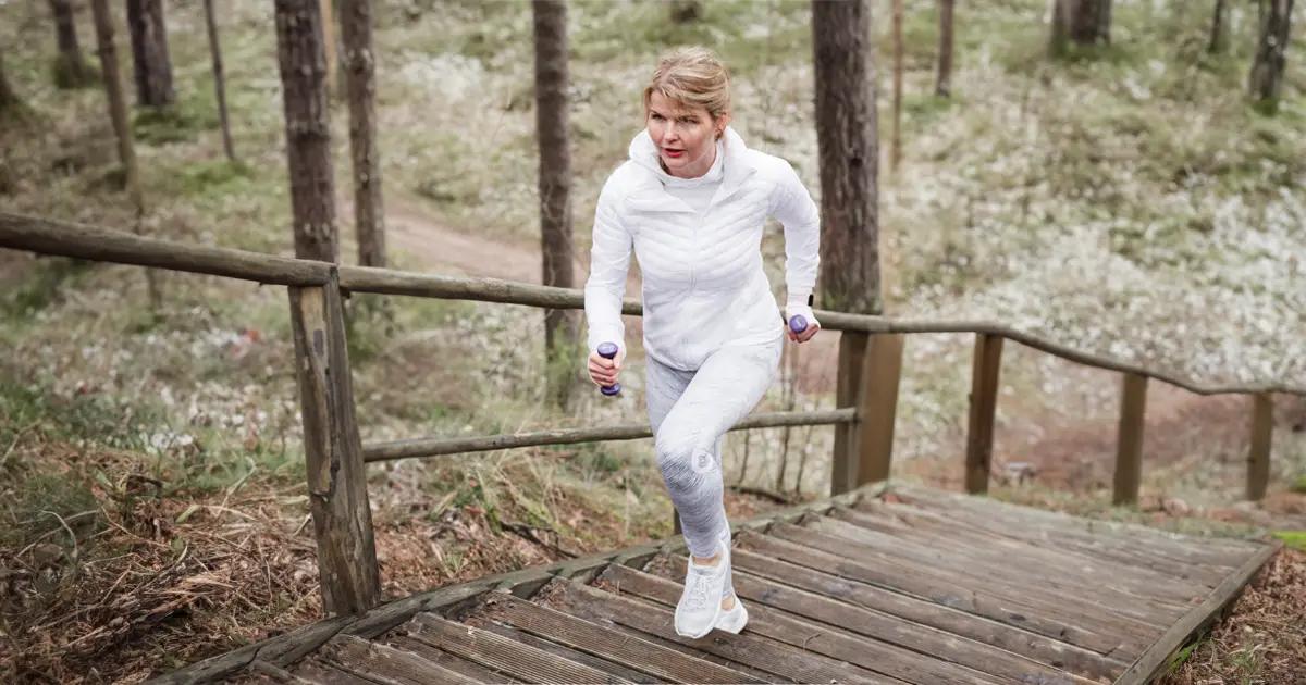 Woman jogging up stairs