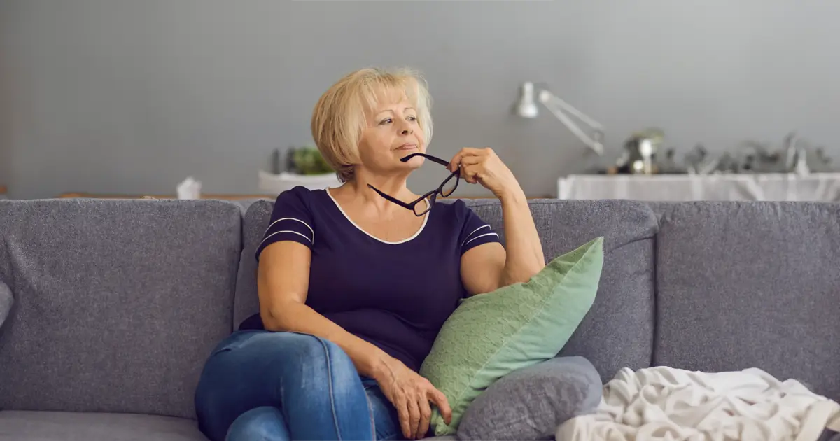 Woman sitting on the couch thinking