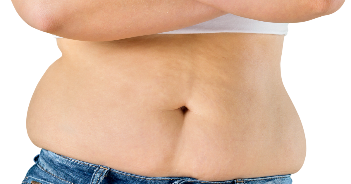 A woman's 'muffin top' of belly fat over the top of her jeans.