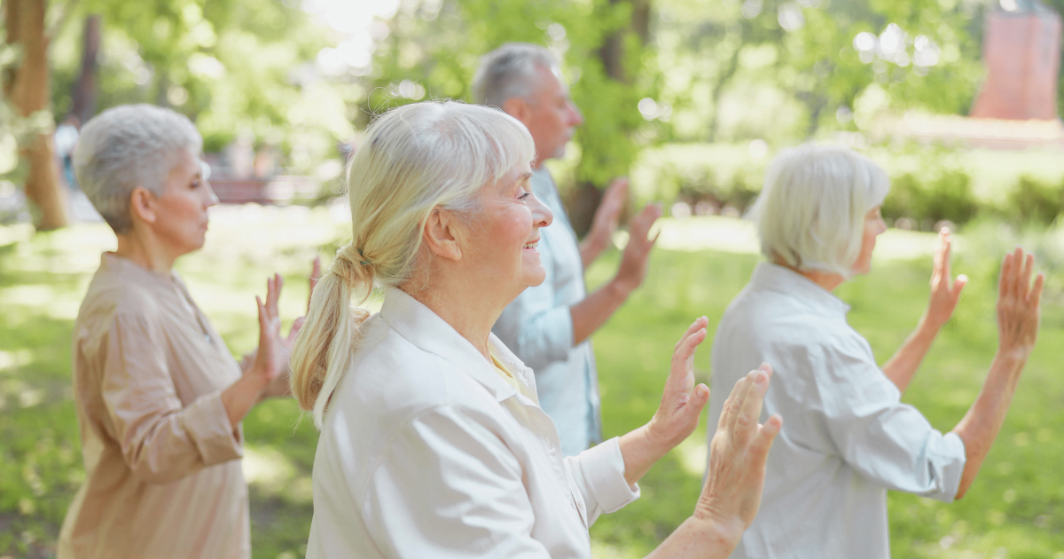 An older woman practicing Tai-Chi with her friends, after using the 7 methods to connect with her spirituality.